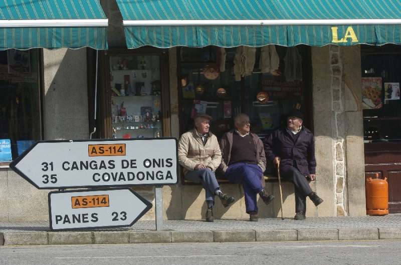 José Corces, Miguel Díaz y Francisco Herrero, sentados al sol del mediodía ante La Tienda Nueva, en la travesía de Arenas