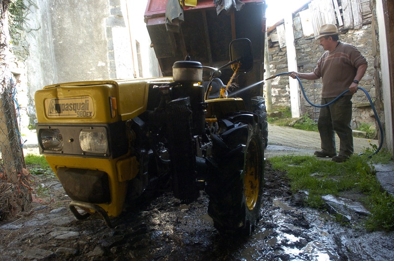 Un hombre lava su tractor.